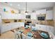 Kitchen features stainless appliances, granite countertops, travertine backsplash and white cabinets at 5608 Holmes Blvd, Holmes Beach, FL 34217