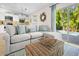 Bright living area featuring a comfortable sectional sofa and sliding glass doors to the pool at 5608 Holmes Blvd, Holmes Beach, FL 34217