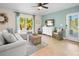 Comfortable living space offering a cozy sectional sofa, a TV, and sliding glass doors to the pool at 5608 Holmes Blvd, Holmes Beach, FL 34217