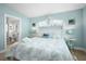 Bedroom with bright turquoise walls, queen size bed, and en suite bathroom at 5608 Holmes Blvd, Holmes Beach, FL 34217