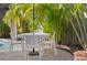 Outdoor seating with patio table, chairs and tropical landscaping at 5608 Holmes Blvd, Holmes Beach, FL 34217