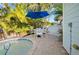 Outdoor dining area features patio table, chairs and landscaping at 5608 Holmes Blvd, Holmes Beach, FL 34217