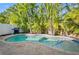 Backyard pool with paver patio and lush landscaping creating a private oasis at 5608 Holmes Blvd, Holmes Beach, FL 34217