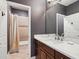 Bathroom vanity with marble countertop and a view of the tub and shower at 5742 Hydrangea Cir, Sarasota, FL 34238