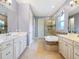 Bright bathroom with double vanity, soaking tub, and walk-in shower at 5742 Hydrangea Cir, Sarasota, FL 34238