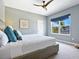 Stylish bedroom with a gray wall, a full-sized bed, and blue accent pillows at 5742 Hydrangea Cir, Sarasota, FL 34238
