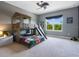 A themed bedroom with a custom bunk bed with a slide and a basketball hoop at 5742 Hydrangea Cir, Sarasota, FL 34238