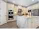 Modern kitchen featuring stainless steel appliances, a large island, and stylish cabinetry at 5742 Hydrangea Cir, Sarasota, FL 34238