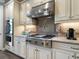 Bright kitchen boasts stainless steel appliances, marble countertops, and mosaic tile backsplash at 5742 Hydrangea Cir, Sarasota, FL 34238