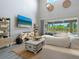 Bright living room with large windows that provide natural light and views of the pool at 5742 Hydrangea Cir, Sarasota, FL 34238