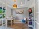Bright office space featuring natural light, built-in bookshelves, and a comfortable sitting area at 5742 Hydrangea Cir, Sarasota, FL 34238