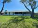 Backyard with a screened-in lanai and mature trees, providing privacy and shade for outdoor enjoyment at 5810 42Nd E St, Bradenton, FL 34203