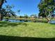 A tranquil backyard features lush grass and a serene canal view in a peaceful setting at 5810 42Nd E St, Bradenton, FL 34203