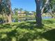 Canal view from the backyard with mature trees and lush grass, perfect for relaxation and outdoor activities at 5810 42Nd E St, Bradenton, FL 34203