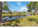 The backyard features mature trees, waterfront views, and a well-maintained lawn at 5810 42Nd E St, Bradenton, FL 34203