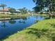 Beautiful waterfront view from the backyard, showcasing the tranquil canal and well-maintained lawn at 5810 42Nd E St, Bradenton, FL 34203
