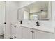 Bathroom featuring double vanity, white cabinets, and a frameless glass-enclosed shower with elegant fixtures at 5810 42Nd E St, Bradenton, FL 34203