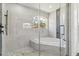 Luxurious bathroom showcasing a soaking tub inside a glass enclosed shower and a decorative accent wall at 5810 42Nd E St, Bradenton, FL 34203