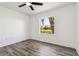 Comfortable bedroom featuring tile flooring, white walls, and a serene view of the backyard through the window at 5810 42Nd E St, Bradenton, FL 34203