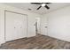Bedroom with wood-look tile flooring, large closet, and ceiling fan at 5810 42Nd E St, Bradenton, FL 34203