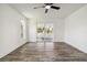 Bright bedroom with wood-look flooring, neutral walls, and sliding glass doors that provide backyard views at 5810 42Nd E St, Bradenton, FL 34203
