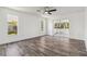 Inviting bedroom with wood-look tile, white walls, and natural light from windows and a glass door to a porch at 5810 42Nd E St, Bradenton, FL 34203