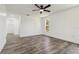 Neutral bedroom with wood-look tile flooring, white walls, and natural light filtering in through the window at 5810 42Nd E St, Bradenton, FL 34203