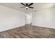 Spacious bedroom with neutral color palette, wood-look tile, and a ceiling fan offering a calming retreat at 5810 42Nd E St, Bradenton, FL 34203