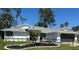 Charming single-story home with a well-manicured lawn and dark gray garage door at 5810 42Nd E St, Bradenton, FL 34203