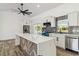 Elegant kitchen boasting white cabinets, tile backsplash, and stylish island design at 5810 42Nd E St, Bradenton, FL 34203