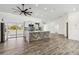 Open-concept living room with tile floors, modern ceiling fan, and kitchen access at 5810 42Nd E St, Bradenton, FL 34203
