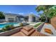 Expansive backyard with pool, hot tub, patio, wooden deck, and privacy fence at 5856 Meriwether Pl, Sarasota, FL 34232