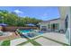 Resort-style backyard with sparkling pool, lounge chairs, mature landscaping, and inviting patio area at 5856 Meriwether Pl, Sarasota, FL 34232