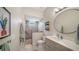 Stylish bathroom with walk-in shower, modern vanity and unique tile work at 5856 Meriwether Pl, Sarasota, FL 34232