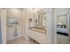 Bright bathroom featuring a vanity with double mirrors, and tiled floor at 5856 Meriwether Pl, Sarasota, FL 34232