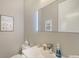 Modern powder room with a sleek vanity, LED mirror, and tasteful decor, perfect for guests at 5856 Meriwether Pl, Sarasota, FL 34232