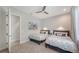 Bright bedroom featuring two twin beds, ceiling fan, and decorative wall art at 5856 Meriwether Pl, Sarasota, FL 34232