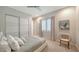 Comfortable bedroom with large window, soft carpet and modern furnishings at 5856 Meriwether Pl, Sarasota, FL 34232