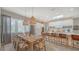 Bright open floor plan, dining and kitchen with large island and comfortable seating, and stylish pendant lighting at 5856 Meriwether Pl, Sarasota, FL 34232