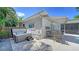 Cozy outdoor patio with hot tub, comfortable seating, and awning, perfect for relaxation at 5856 Meriwether Pl, Sarasota, FL 34232