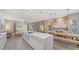 Bright open floor plan, dining and kitchen with large island, with a view of the outdoor living area, great for entertaining at 5856 Meriwether Pl, Sarasota, FL 34232