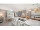 Bright open-concept kitchen with a marble island, stainless steel appliances, and a seamless flow into the living area at 5856 Meriwether Pl, Sarasota, FL 34232
