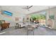 Bright and airy living room with a comfortable sectional sofa, stylish decor, and seamless indoor-outdoor flow at 5856 Meriwether Pl, Sarasota, FL 34232