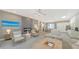 Spacious living area featuring a fireplace, sleek modern decor, and seamless flow to the kitchen and dining area at 5856 Meriwether Pl, Sarasota, FL 34232