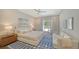 Serene main bedroom with a private outdoor access, a cozy seating area, and ample natural light at 5856 Meriwether Pl, Sarasota, FL 34232