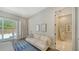 Cozy seating area in main bedroom with an ensuite and large sliding doors to the exterior at 5856 Meriwether Pl, Sarasota, FL 34232