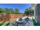 Inviting patio featuring modern furniture, an outdoor fire pit, and beautiful landscaping for relaxing and entertaining at 5856 Meriwether Pl, Sarasota, FL 34232