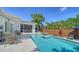 Gorgeous pool area with lounge chairs, tropical landscaping, and a screened-in porch for outdoor living at 5856 Meriwether Pl, Sarasota, FL 34232