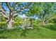 A peaceful backyard scene with a swing bench overlooking the lake, offering a serene retreat at 622 147Th E St, Bradenton, FL 34212