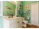 Bathroom showcasing a stylish vanity, nautical decor, and a fresh, inviting green color at 622 147Th E St, Bradenton, FL 34212